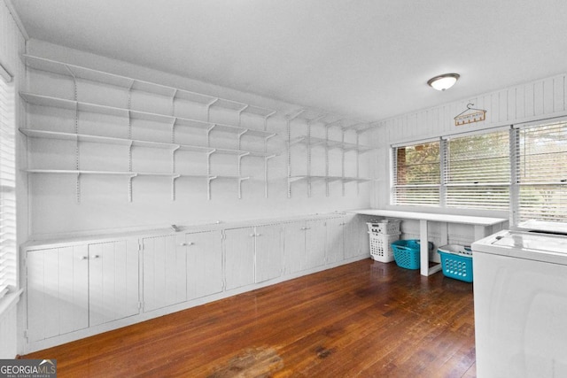 unfurnished office with dark wood-type flooring and washer / dryer