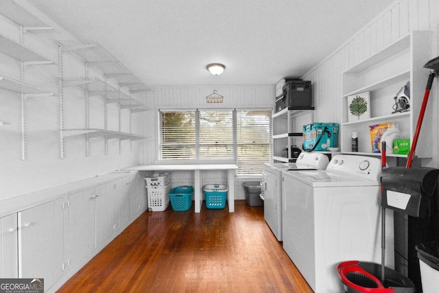 washroom with washer and dryer and wood finished floors
