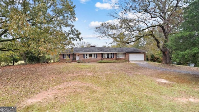 ranch-style house with driveway, a garage, brick siding, and a front lawn