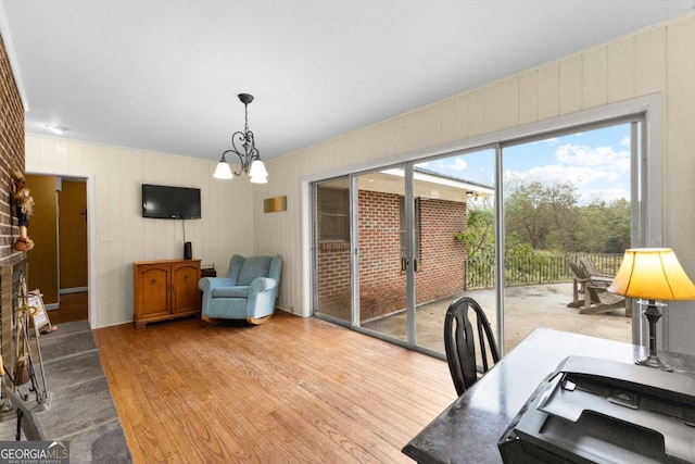 dining room featuring wood-type flooring and a chandelier