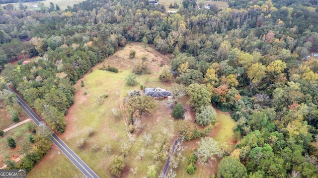 aerial overview of property's location with a heavily wooded area