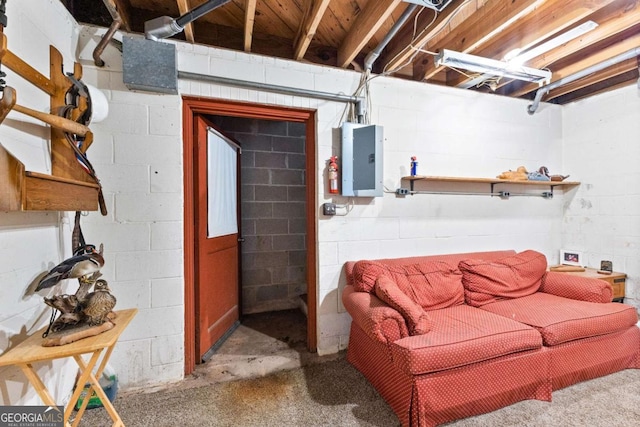 unfinished basement featuring electric panel and concrete block wall