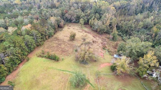 aerial overview of property's location with a heavily wooded area
