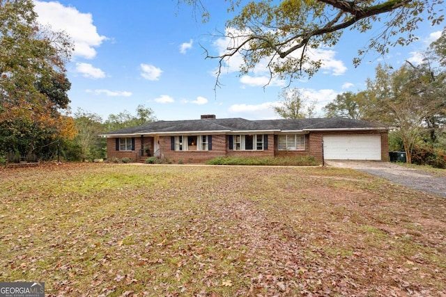 ranch-style home with a garage, driveway, brick siding, and a front yard