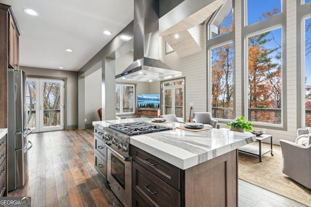 105 Yonah Vw, Dahlonega, GA 30533 - kitchen with appliances with stainless steel finishes, island exhaust hood, dark wood-style floors, a high ceiling, and light stone countertops