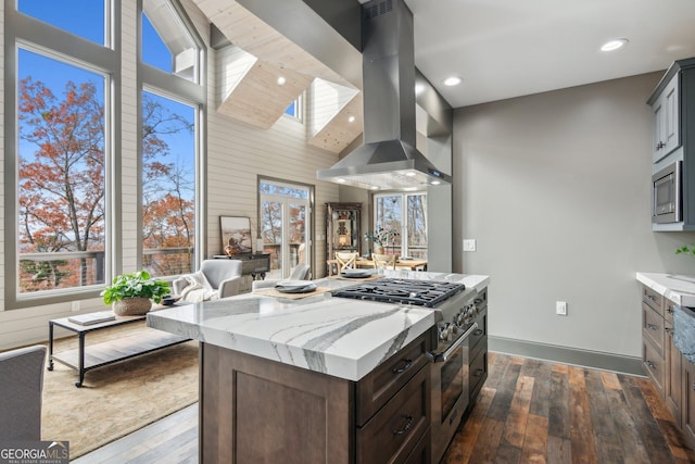 105 Yonah Vw, Dahlonega, GA 30533 - kitchen with stainless steel appliances, island range hood, dark wood-style flooring, healthy amount of natural light, and a towering ceiling