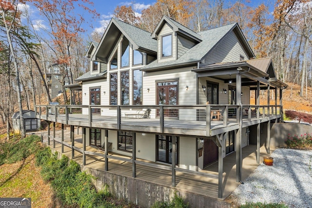 105 Yonah Vw, Dahlonega, GA 30533 - back of house with a shed, a shingled roof, an outbuilding, a patio area, and a deck