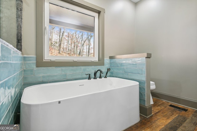 105 Yonah Vw, Dahlonega, GA 30533 - full bathroom featuring toilet, a freestanding tub, tile walls, and wood finished floors