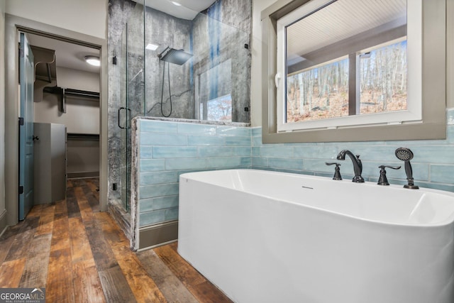 105 Yonah Vw, Dahlonega, GA 30533 - full bath featuring a stall shower, wood-type flooring, a soaking tub, and a spacious closet