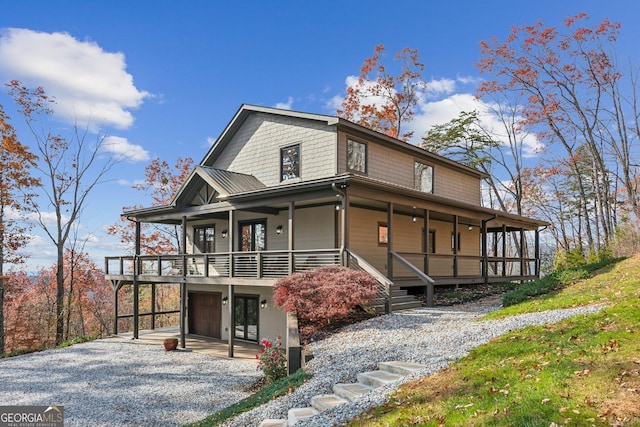 105 Yonah Vw, Dahlonega, GA 30533 - view of front facade featuring gravel driveway, a garage, and covered porch