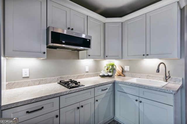105 Yonah Vw, Dahlonega, GA 30533 - kitchen featuring stainless steel microwave, a sink, light countertops, black gas stovetop, and white cabinets