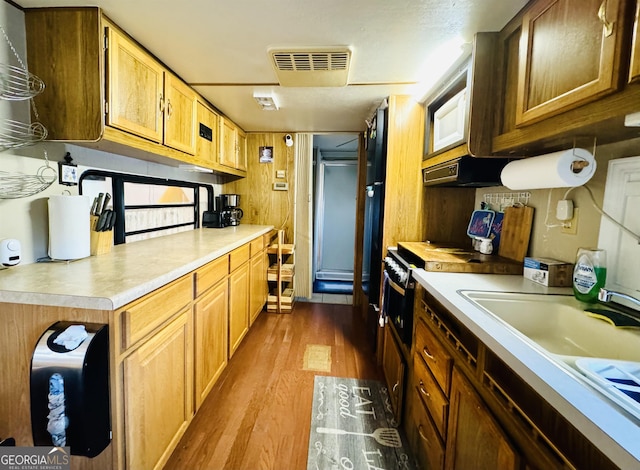 91 Rocky Ln, Cleveland, GA 30528 - kitchen featuring dark wood finished floors, a sink, light countertops, and under cabinet range hood
