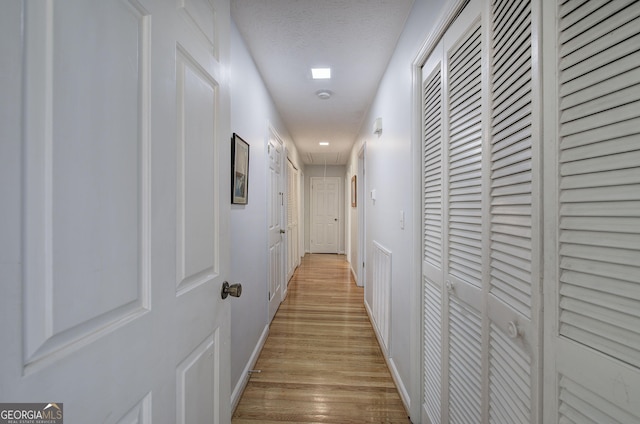 567 Fred Kelley Rd NE, Rome, GA 30161 - hallway with attic access, light wood-style floors, and baseboards