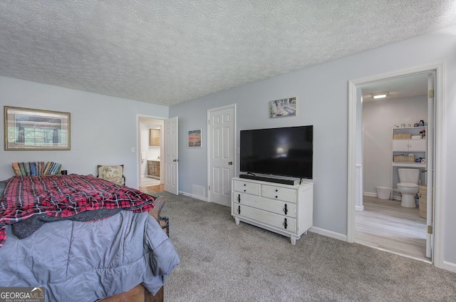 567 Fred Kelley Rd NE, Rome, GA 30161 - bedroom with ensuite bathroom, carpet flooring, baseboards, and a textured ceiling