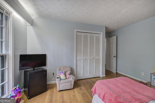 567 Fred Kelley Rd NE, Rome, GA 30161 - bedroom featuring wood finished floors, a closet, baseboards, and a textured ceiling