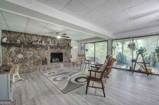 567 Fred Kelley Rd NE, Rome, GA 30161 - living room with a drop ceiling, ceiling fan, wood finished floors, and a fireplace