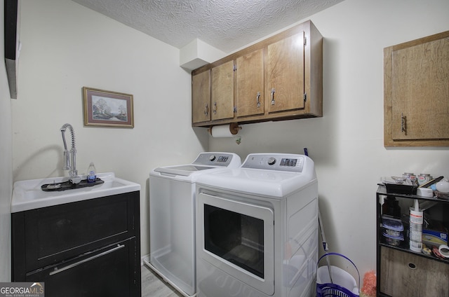 567 Fred Kelley Rd NE, Rome, GA 30161 - washroom featuring washing machine and dryer, cabinet space, and a textured ceiling