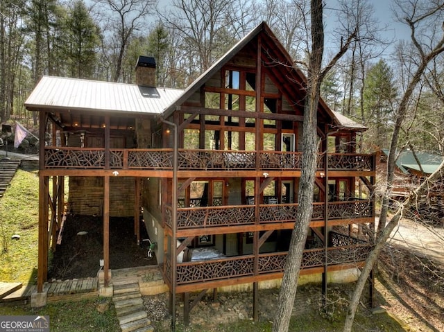 455 Misty Mountain Trl, Morganton, GA 30560 - back of property with a chimney, metal roof, and a deck