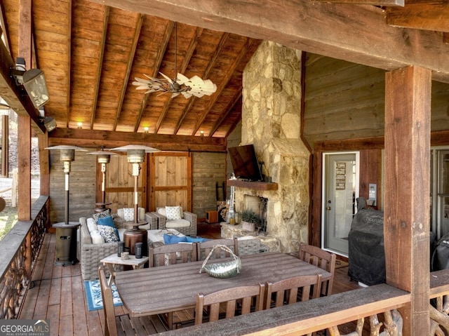 455 Misty Mountain Trl, Morganton, GA 30560 - unfurnished dining area with wood ceiling, wood-type flooring, wood walls, a wood stove, and beam ceiling