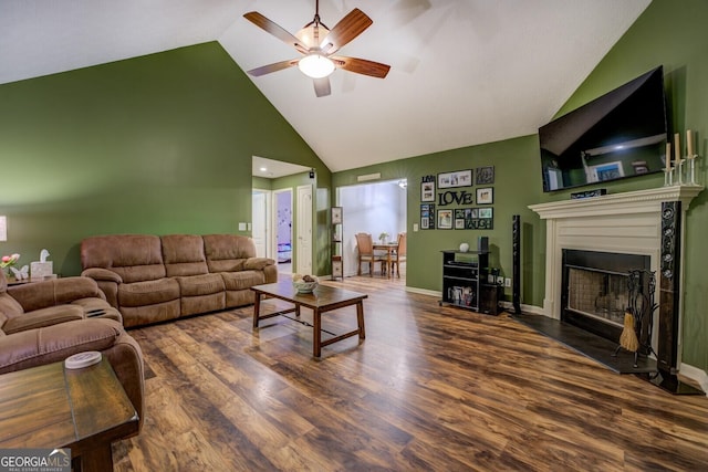 living area with high vaulted ceiling, ceiling fan, wood finished floors, and a fireplace