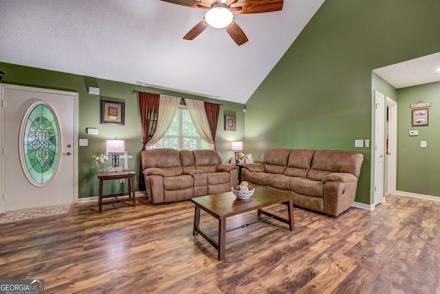 living area with ceiling fan, high vaulted ceiling, wood finished floors, and baseboards