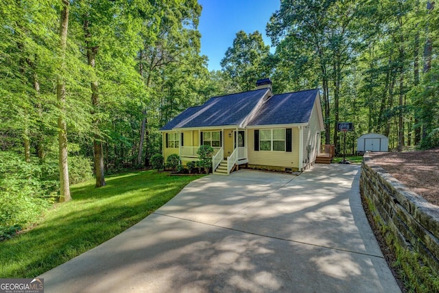 view of front of home with a storage shed, concrete driveway, covered porch, an outdoor structure, and a chimney