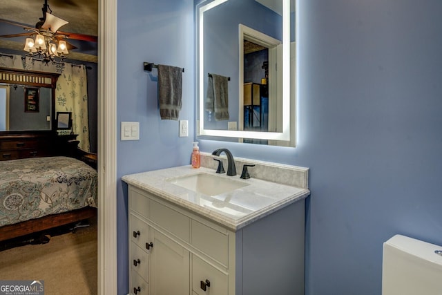 bathroom with vanity, ceiling fan, and ensuite bathroom
