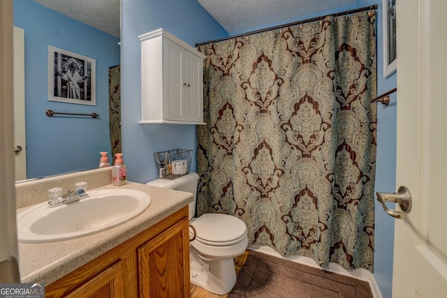 bathroom with a textured ceiling, toilet, vanity, and a shower with shower curtain