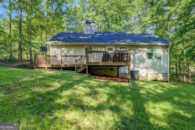 rear view of house with a chimney, a wooden deck, a yard, and cooling unit