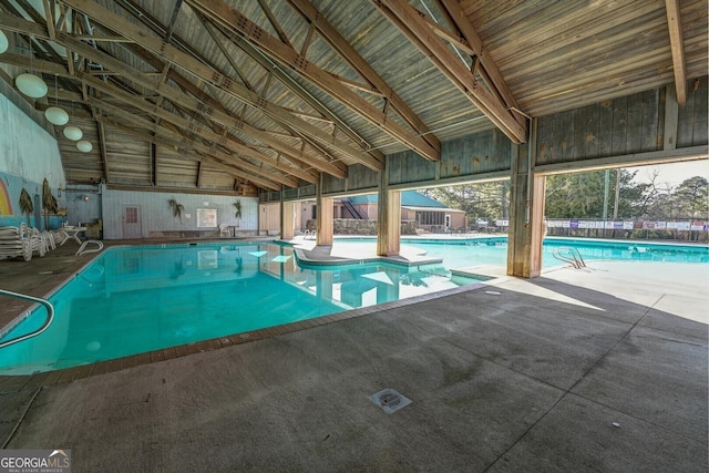indoor community pool featuring a patio area