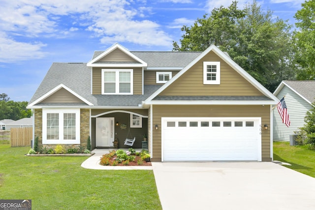 506 Hide Away Lake Loop, Kingsland, GA 31548 - view of front of home with roof with shingles, driveway, stone siding, an attached garage, and covered porch