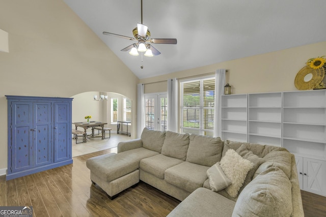 506 Hide Away Lake Loop, Kingsland, GA 31548 - living room featuring arched walkways, a ceiling fan, high vaulted ceiling, wood finished floors, and a chandelier