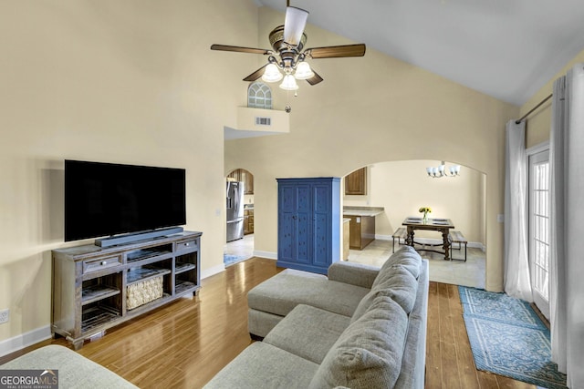 506 Hide Away Lake Loop, Kingsland, GA 31548 - living room with arched walkways, ceiling fan, wood finished floors, high vaulted ceiling, and baseboards