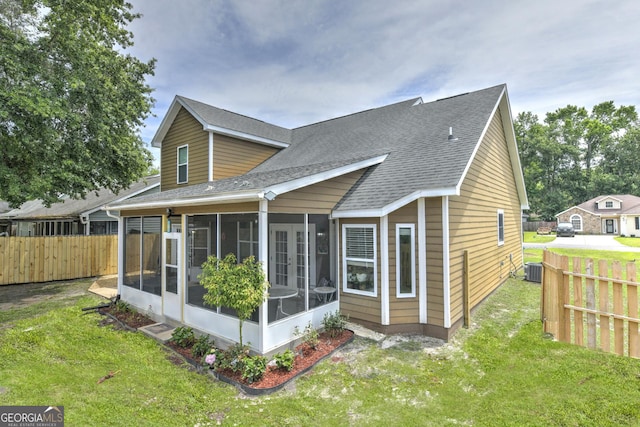506 Hide Away Lake Loop, Kingsland, GA 31548 - rear view of house with a sunroom, a shingled roof, and central air condition unit