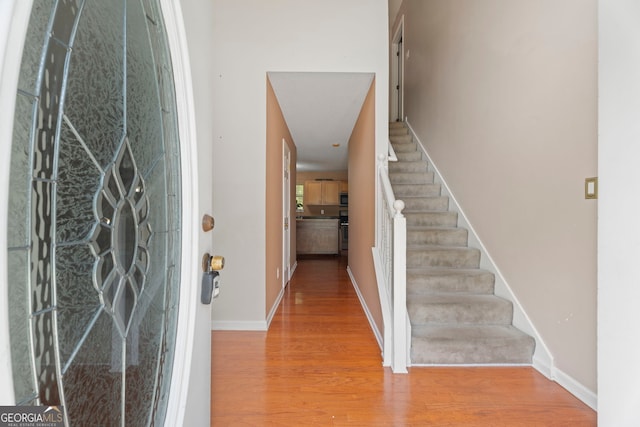 96 Ashtonbrook Dr, Mcdonough, GA 30252 - entrance foyer with wood finished floors, stairway, and baseboards