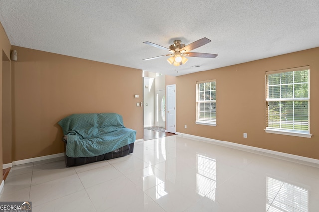 96 Ashtonbrook Dr, Mcdonough, GA 30252 - sitting room with light tile patterned floors, plenty of natural light, a textured ceiling, a ceiling fan, and baseboards