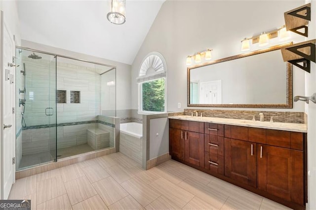 5652 Harbormist Dr, Powder Springs, GA 30127 - bathroom featuring a bath, a stall shower, double vanity, high vaulted ceiling, and tile patterned floors