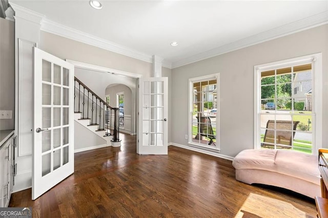 5652 Harbormist Dr, Powder Springs, GA 30127 - sitting room featuring french doors, arched walkways, ornamental molding, wood finished floors, and baseboards
