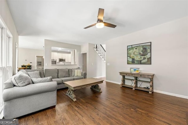 5652 Harbormist Dr, Powder Springs, GA 30127 - living room with wood finished floors, stairway, a ceiling fan, and baseboards