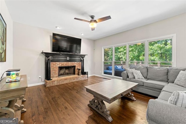 5652 Harbormist Dr, Powder Springs, GA 30127 - living room featuring ceiling fan, a brick fireplace, wood finished floors, baseboards, and recessed lighting