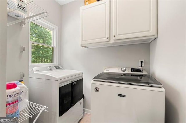 5652 Harbormist Dr, Powder Springs, GA 30127 - clothes washing area with independent washer and dryer and cabinet space