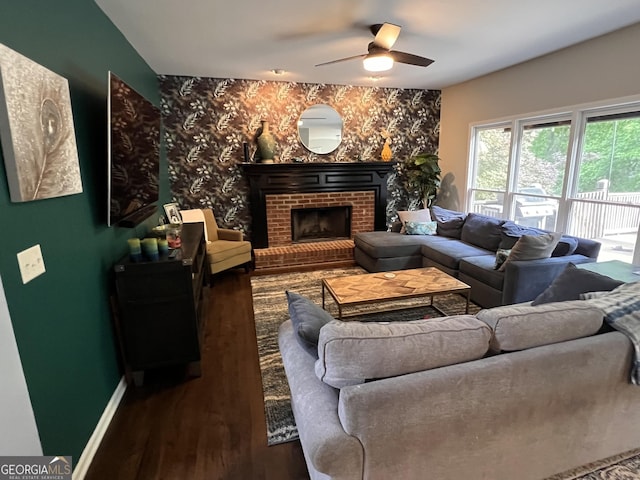 5652 Harbormist Dr, Powder Springs, GA 30127 - living room featuring wood finished floors, a ceiling fan, a fireplace, and baseboards