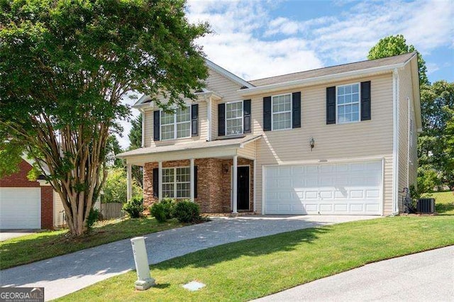 traditional-style house featuring a garage, central air condition unit, a front lawn, and concrete driveway