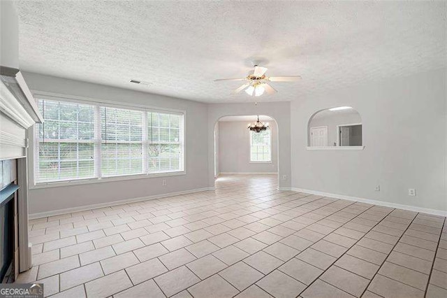 45 Waterloo Ct, Hiram, GA 30141 - empty room with a textured ceiling, ceiling fan, arched walkways, a chandelier, and tile patterned flooring