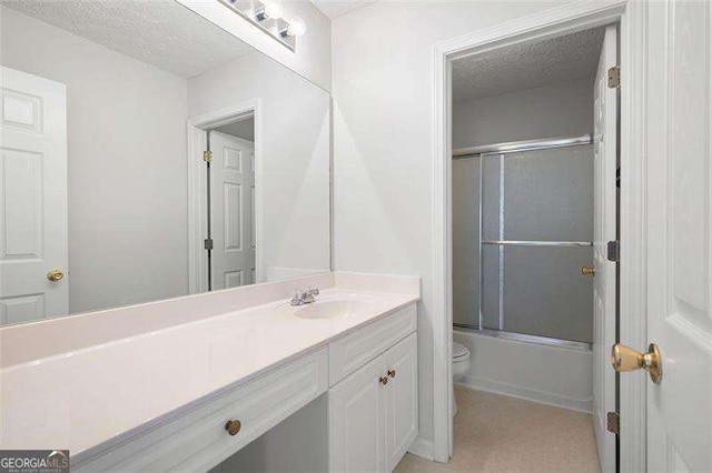 full bathroom with toilet, vanity, a textured ceiling, and shower / bath combination with glass door