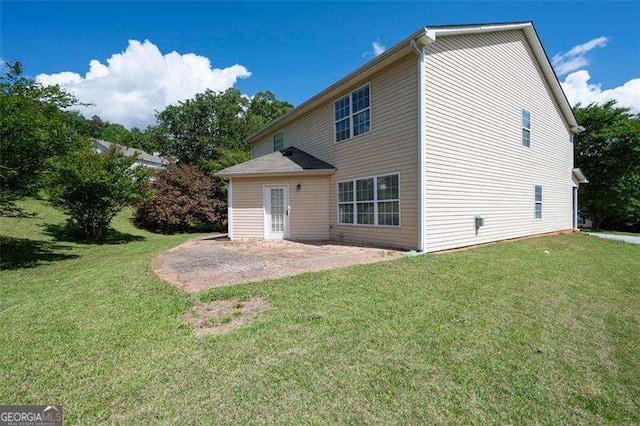 rear view of house featuring a patio and a lawn