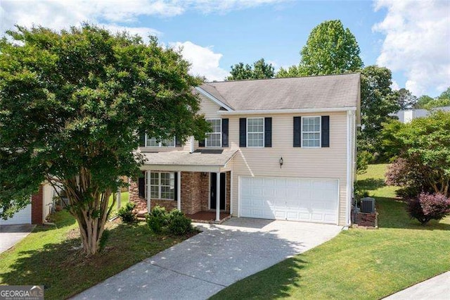 view of front of house featuring a garage, driveway, and a front lawn