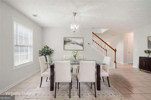 45 Waterloo Ct, Hiram, GA 30141 - dining area with stairs, a chandelier, a textured ceiling, and light tile patterned floors