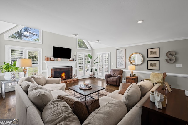 living area with wood finished floors, vaulted ceiling, a fireplace, plenty of natural light, and recessed lighting