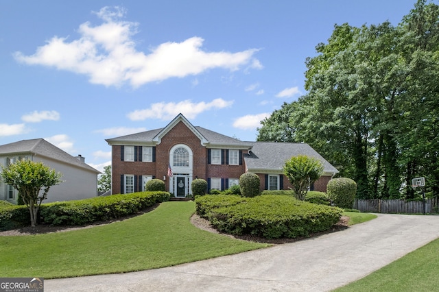 colonial house featuring brick siding